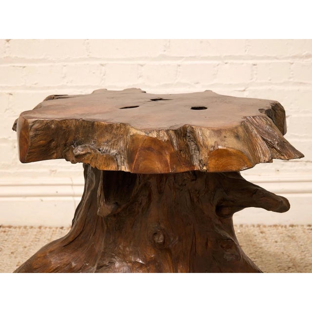 A wonderfully sculptural vintage side table crafted from a thick natural slab of richly figured wood set atop an organic...