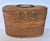 Antique Chinese wicker lunch basket lined with lovely floral fabric. Has double handles on the top, 3-ring hinge at the...