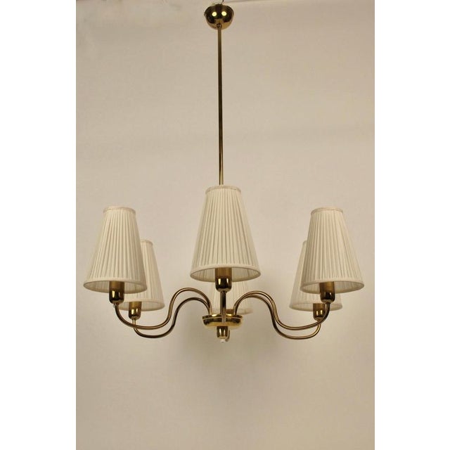 A beautiful, six arm chandilier from rupert nikoll, made in the 1950's, in austria. The brass elements have had the...