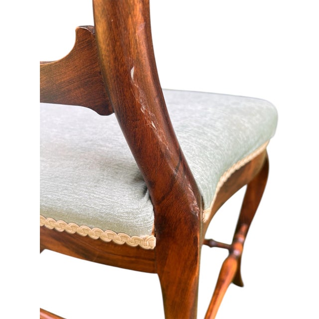 A rare and unusual antique parlor chair in rosewood with carved backrest and upholstered seat. Dating from the mid-late...