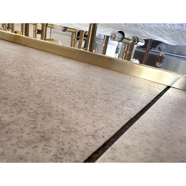 Huge rectangular wall sconce in unlaquered brass and Transparent Murano glass with a diamanted texture that give brigtness...