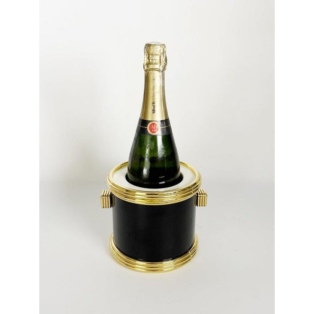 Elegant French ice bucket by Lancel, dating from the 1970s. The cylindrical body features a sophisticated black finish...