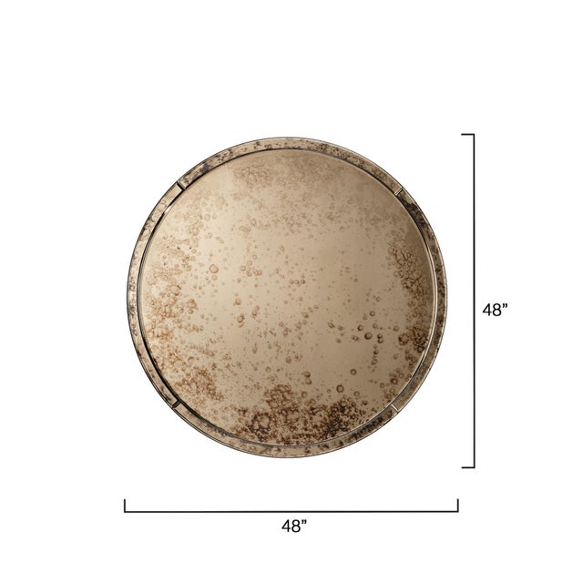 Encircled in mirrored panels and centered with antique glass, this large round mirror is finished in a warm brown patina....