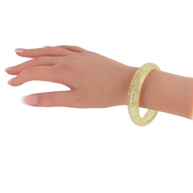 This lovely Lucite bracelet bangle features a domed shape and is crafted from transparent, lemon-yellow Lucite with silver...