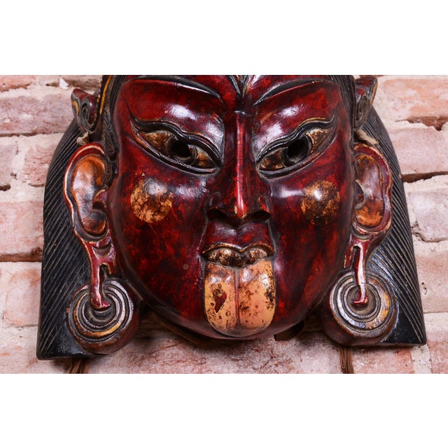 This original Asian mask, originating from before 1900, represents an extraordinary, highly valued, and collector-...
