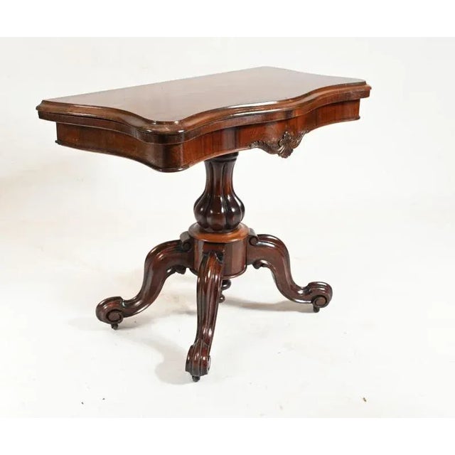 Elegant period Victorian games table in rosewood We date this to circa 1860 Top opens out to reveal green beize lined...