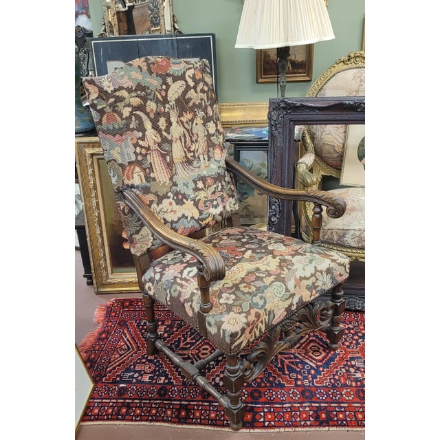 Antique ca 1890 Jacobean needlepoint large arm chair. Features carved hardwood frame, needlepoint upholstery depicting a...