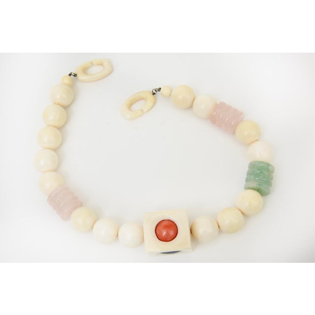 This stunning vintage 1960's collar necklace is ivory large beads with interspersed Jade, Pink Quartz, Amethyst, Malachite...