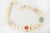 This stunning vintage 1960's collar necklace is ivory large beads with interspersed Jade, Pink Quartz, Amethyst, Malachite...