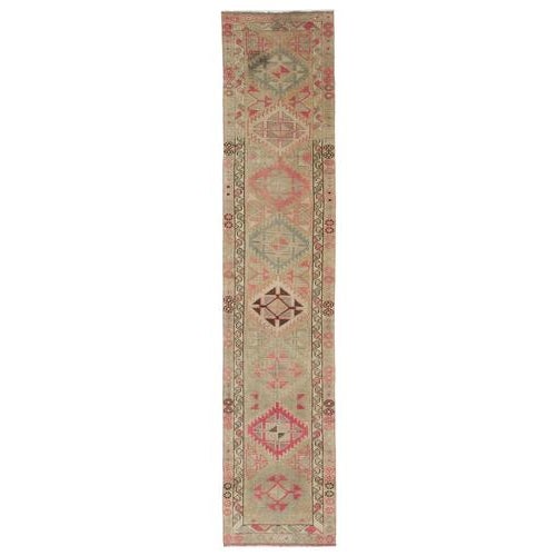 This exquisite runner rug is a rare example of tribal craftsmanship, hand-knotted by the women of the Herki tribe during...