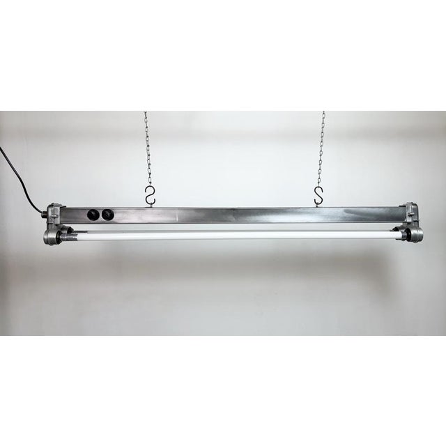 This industrial tube light was made by msi "gwarancja" olsztyn in poland during the 1970s. It is made of iron and an...