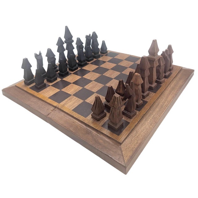 Offered is a vintage set of 1980s African hand-carved and chiseled chess pieces. There are 16 of each of the ebonized and...