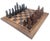 Offered is a vintage set of 1980s African hand-carved and chiseled chess pieces. There are 16 of each of the ebonized and...