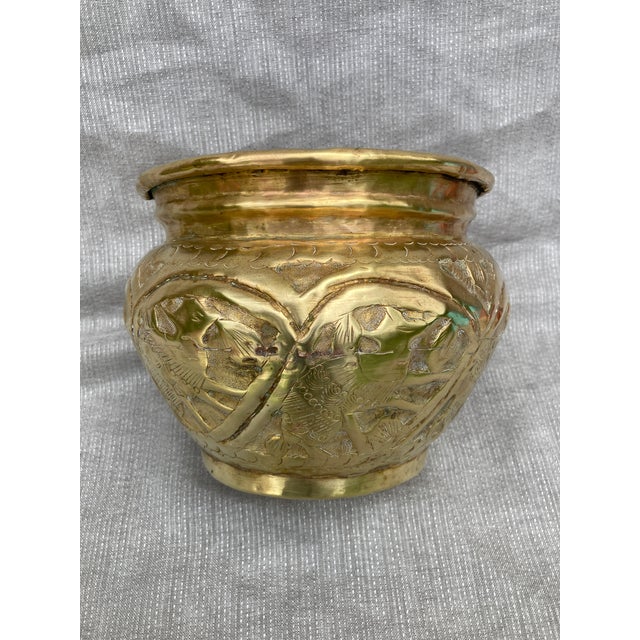 Vintage heavily embossed, polished, hand wrought brass planter. Beautiful patina. It measures 8" by 8" by 6". Wear is...