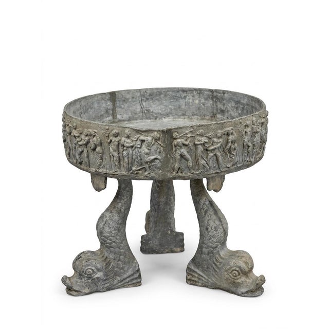 A grand and heavy-set neoclassical garden basin or planter, masterfully crafted in lead with a rich, authentic oxidized...