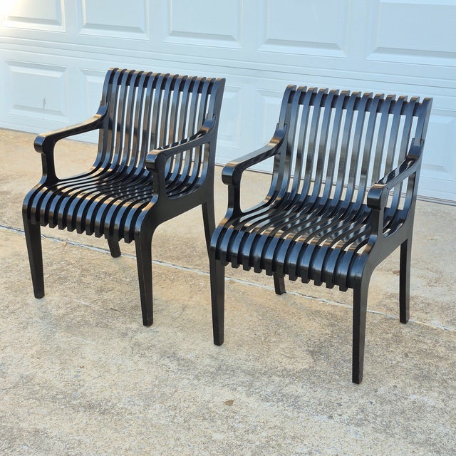 This is an arresting pair of slatted arm chairs in the style of Thonet but with a midcentury modern flair. They could be...