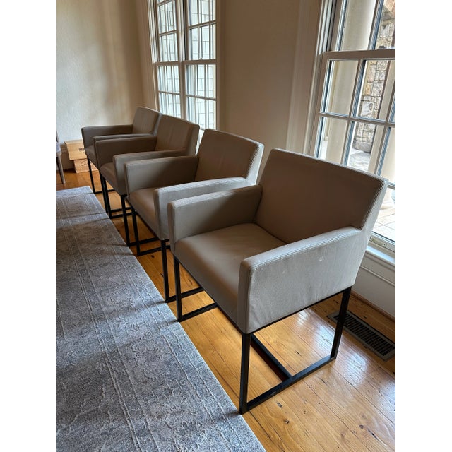 EMERY TRACK ARM LEATHER DINING ARMCHAIR Italian Cavallino Leather Smoke & Bronze A tubular steel base gives our postmodern...