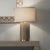 Antique brass details add warmth to a crisp and modern cement body to create this perfect lamp for any home. The thick,...