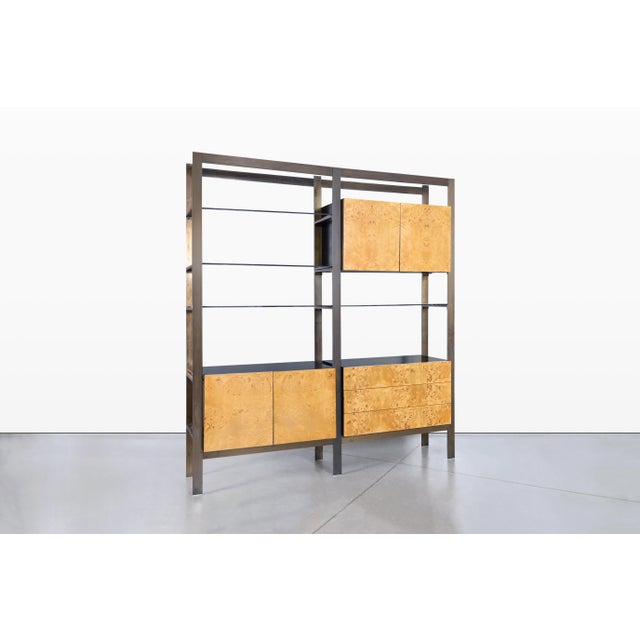 This stunning mid-century modern freestanding wall unit is a true masterpiece designed by John Stuart and crafted by West...