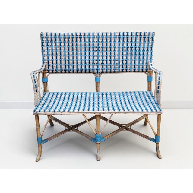 Two-seater woven rattan bench, predominantly blue, in a scoubidou style / Circa 1950s The bench is in good condition, with...