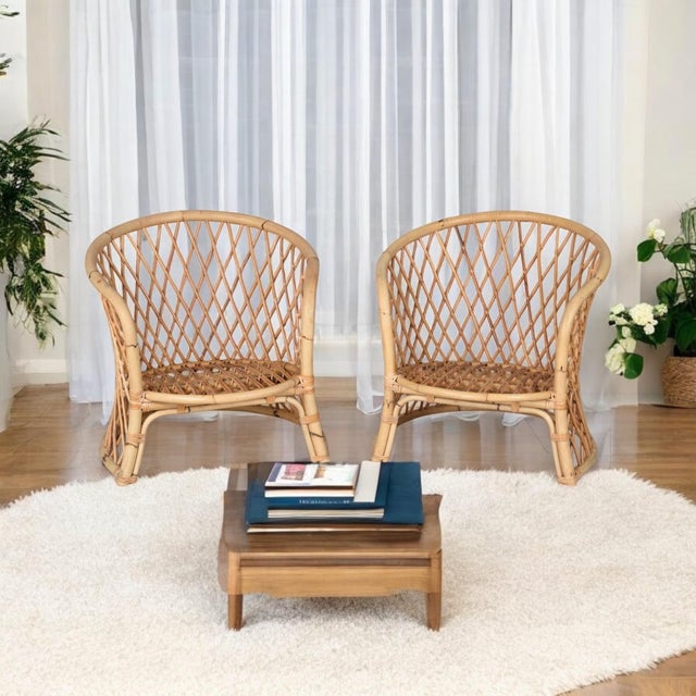 Elegant pair of vintage barrel back rattan lounge chairs. These chairs bridge many styles from coastal, to boho, and cozy...