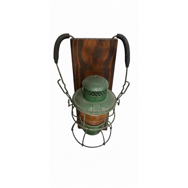 A distinctive and highly decorative pair of vintage railroad lanterns repurposed as wall-mounted sconces, each featuring...