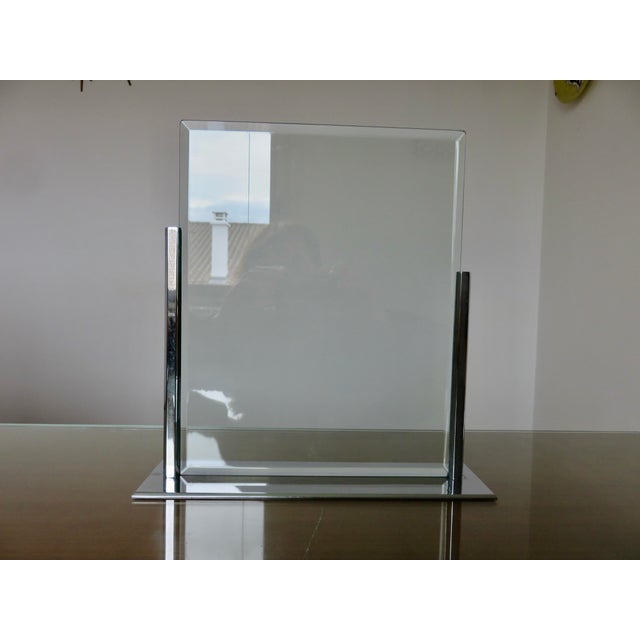 French Art Deco photo frame in the style of Jacques Adnet. 1930s. It is made of chromed brass and the two glass panes are...