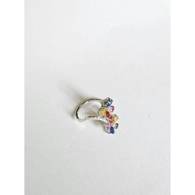 A very gorgeous and dainty, modern style, Multi Sapphires Engagement Ring set in 18K White Gold & natural Diamonds. The...