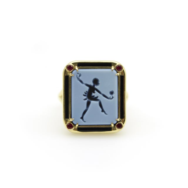 This 18k gold ring features the image of Josephine Baker, beautifully carved into a grey-blue banded agate intaglio. We...
