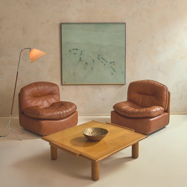 A mid-20th-century Italian square coffee table, crafted in solid oak. Broad in stance and low to the floor, the table...