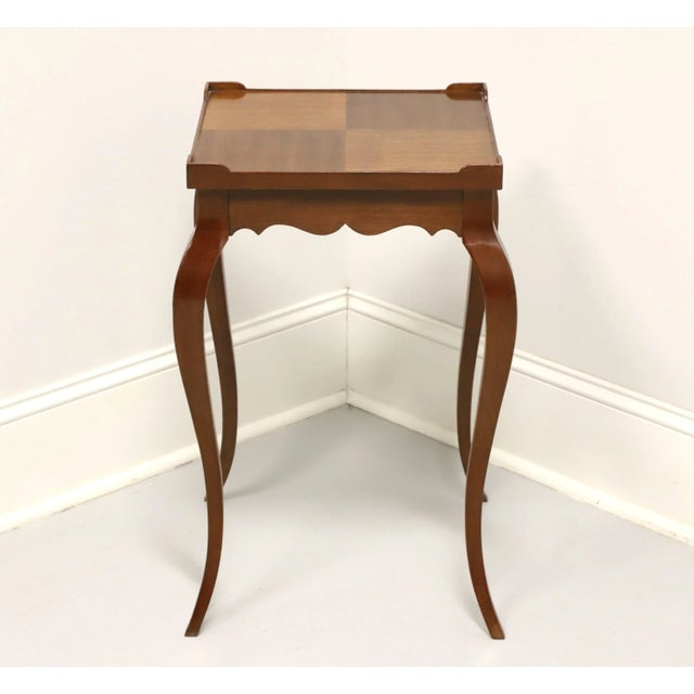 A French Louis XV style side table by Hekman Furniture, of Lexington, North Carolina, USA. Walnut with inlaid parquetry to...