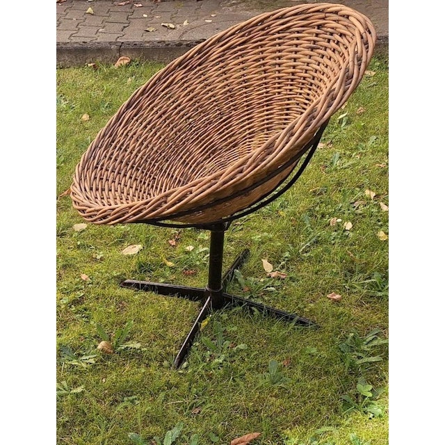 Rattan 1960s pod lounge, cocktail or patio chair on an iron base. Unusually the chair has a swivel function through 360...