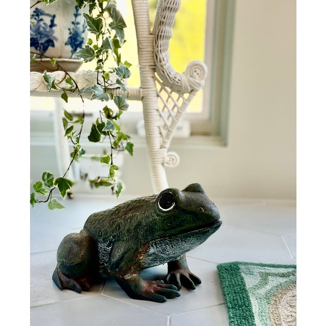 A vintage cast iron frog of exceptional weight and charm, with a naturally aged surface. Likely dating to the early 20th...