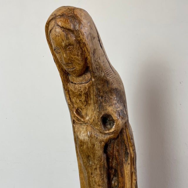 Naïve sculpture of a woman (Virgin Mary) carved from root wood with a natural patina, folk art. What distinguishes folk...