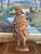This hand-carved wooden sculpture depicts a robed bearded traveler or pilgrim, rendered in a rustic, traditional folk art...