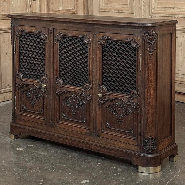 Antique Liegoise Louis XIV Credenza with Lattice Doors is a remarkably well preserved example of the fine craftsmanship...