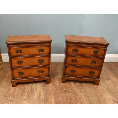 Pair of elegant burr walnut bachelor bedside chests in the Georgian Revival taste Each chest features three graduating...
