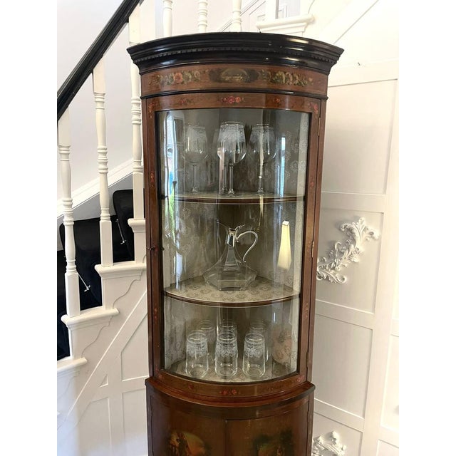 Antique victorian quality mahogany and painted decorated bow fronted corner display cabinet having a moulded cornice above...