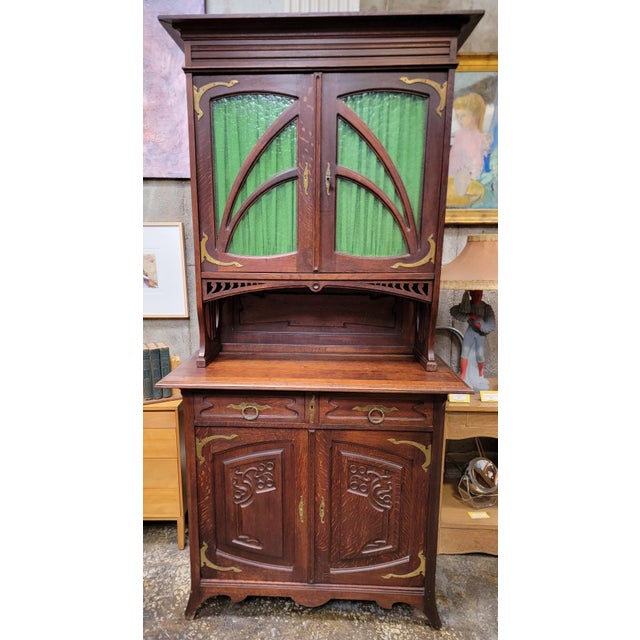 Early 20th century, graceful and organic Art Nouveau 2 piece cabinet. Crafted in oak, circa. 1890-1915. The Art Nouveau...