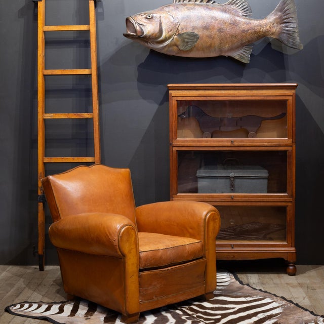 ABOUT An antique modular lawyer's bookcase made of solid Oak with brass knobs, graduated glass doors that open and slide...