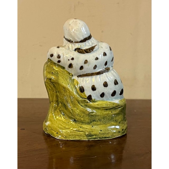 Antique 18th century English George III Staffordshire prattware figure of an old woman. She wears a polka dot classical...