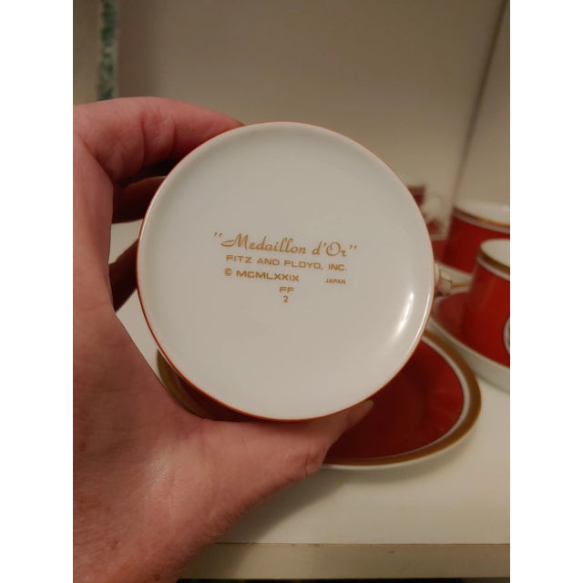 Here's a nice vibrant set of 6 Fitz and Floyd Medaillon d'Or cups and saucers. These are a red orange or terracotta color....