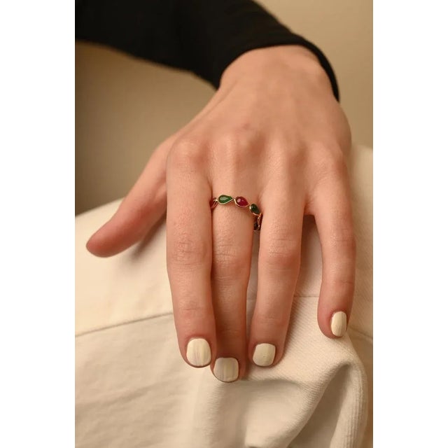 This is part of Chairish’s Fine Jewelry assortment. Alternate Ruby and Emerald Eternity Band Ring in 18K gold symbolizes...