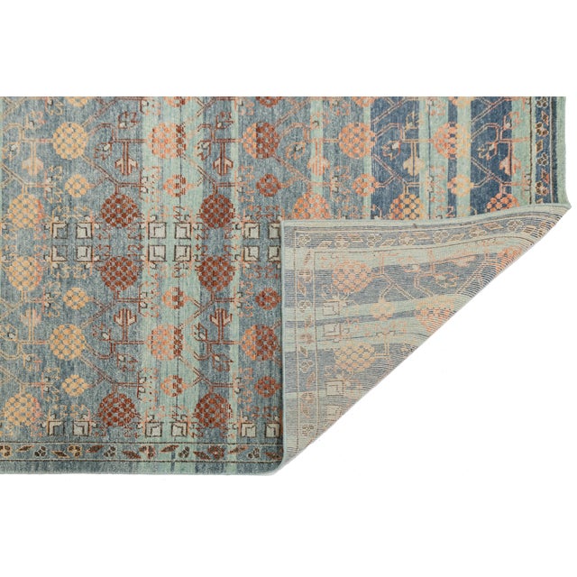Elevate your space with this stunning modern area rug, inspired by Apadana's vintage Khotan designs. Crafted from premium...