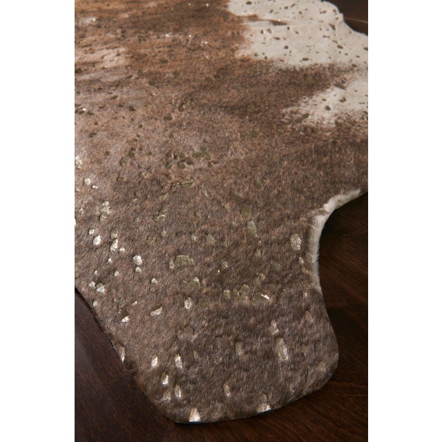 A compelling variant of the timeless cowhide rug, the Bryce Collection touts rich metallic accents set against versatile...