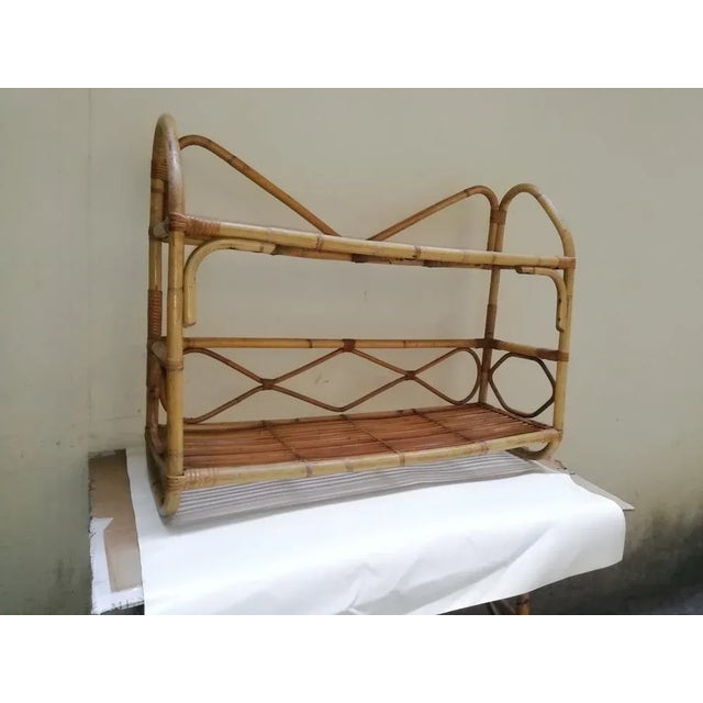 Wall-mounted wicker étagère produced in Italy in the 1960s. Compact size. Ideal for any room. In good overall condition....