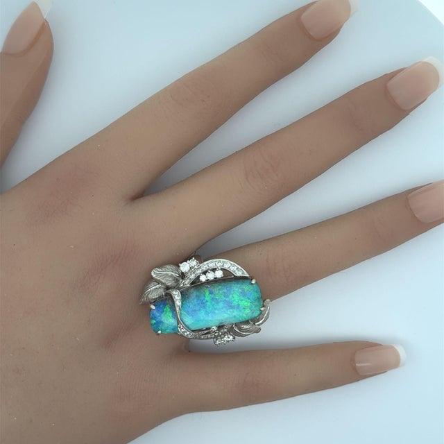 A large, beautiful, and impressive Australian boulder opal takes center stage. It weighs a substantial 16.39 carats and...