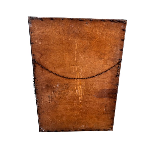 A striking original Arts & Crafts wall mirror dating to circa 1900, featuring a substantial hand-hammered frame crafted in...