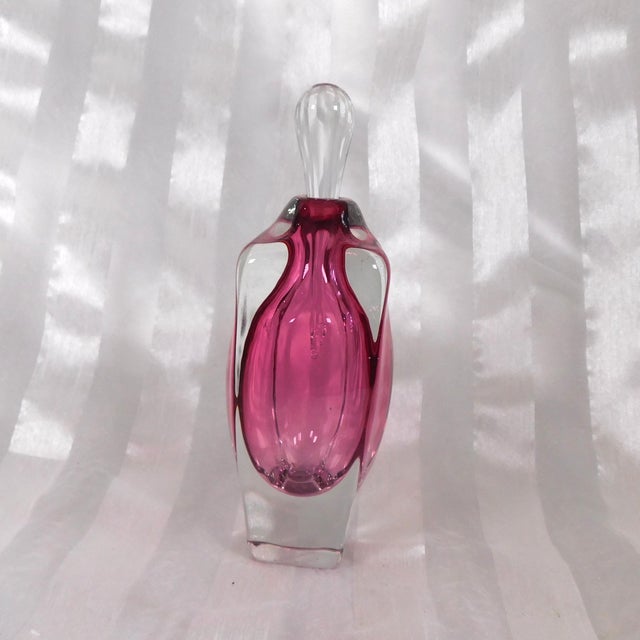 This is a pink perfume bottle signed Winfisky 1998 as shown. It has a clear teardrop stopper that fits well and the pink...