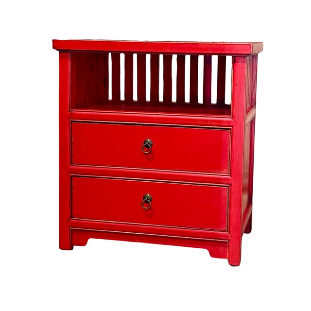 This vintage Chinese bedside cabinet is crafted from solid wood and finished in a rich red lacquer, symbolizing good...